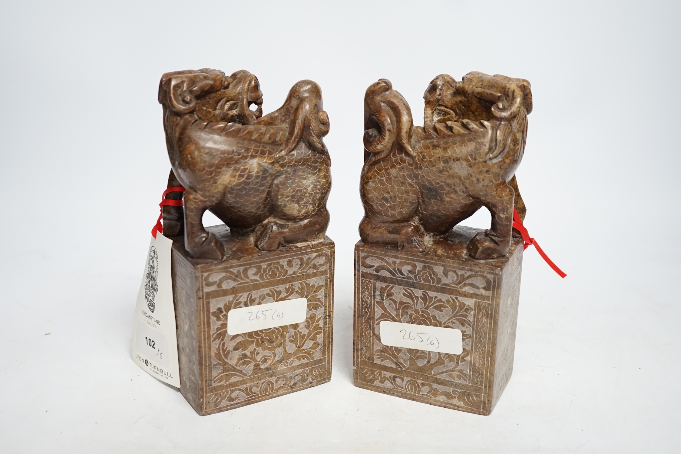 A pair of Chinese soapstone lion-dog and cub seals, 19cm high